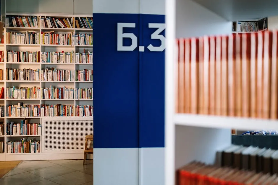 A long aisle of wooden bookshelves stretching into a quiet library, suggesting an archive of durable organisational knowledge