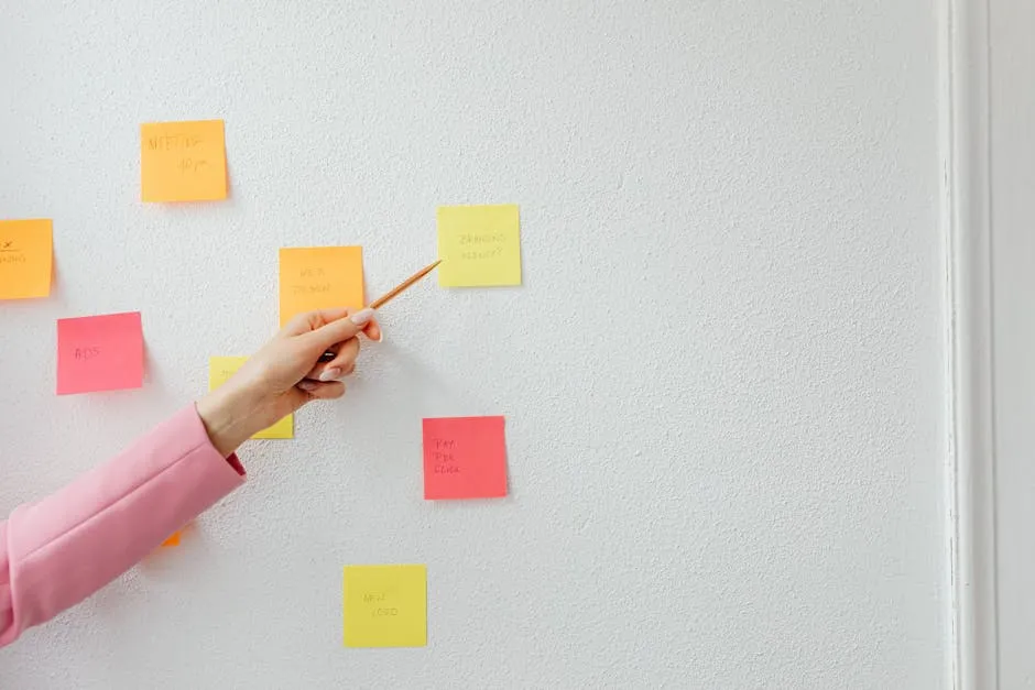 A wall covered in coloured sticky notes arranged in clusters, captured during a team workshop