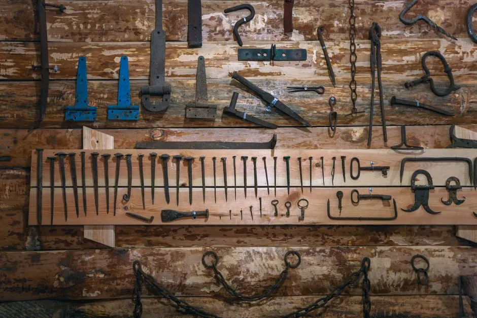 An assortment of varied vintage tools arranged on a workshop wall, suggesting that different jobs call for different tools